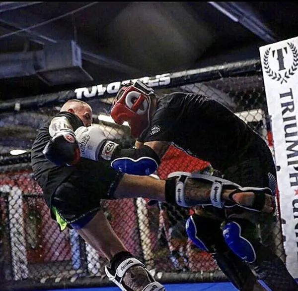 Two fighters clashing with high kicks inside the cage