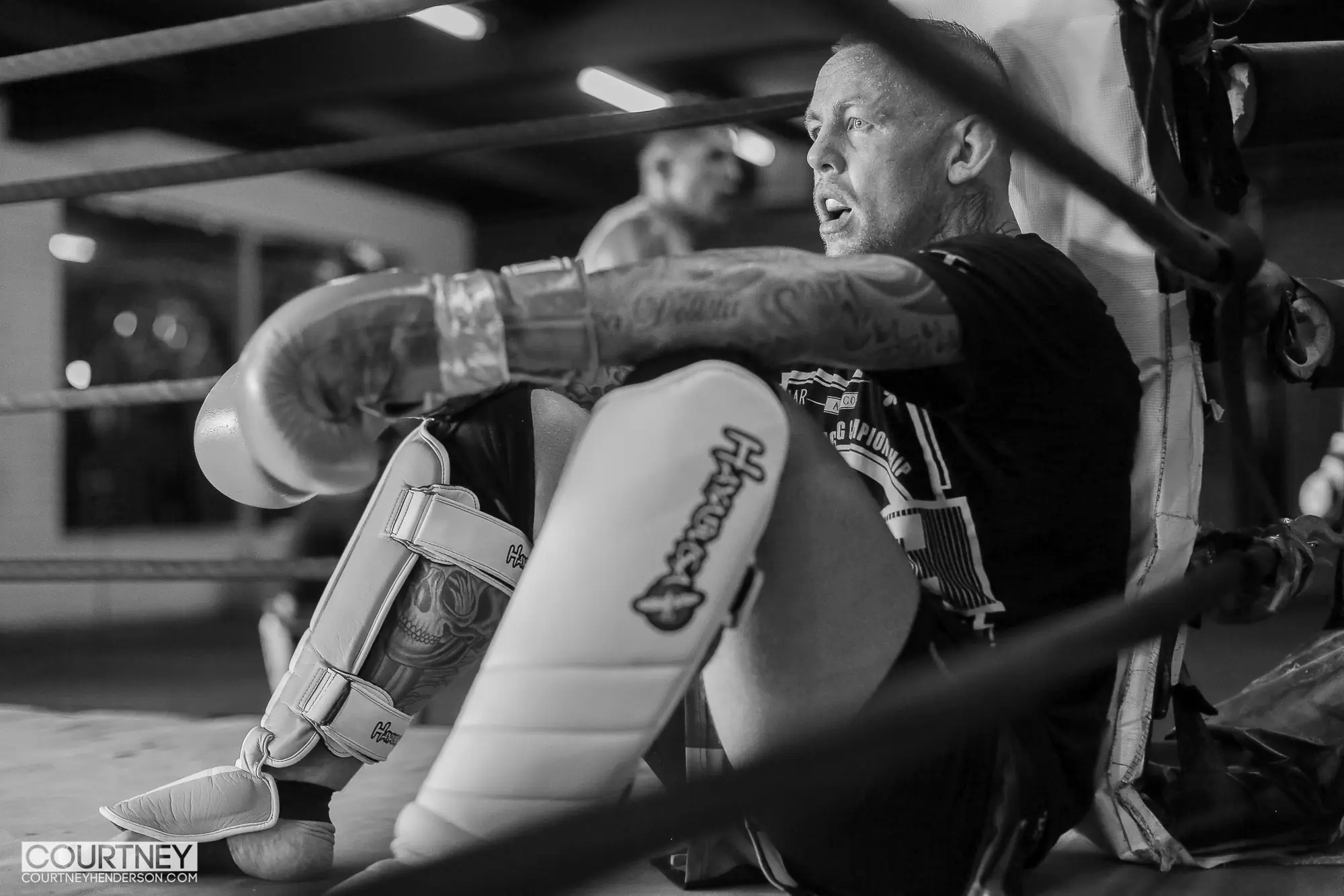 Ross Pearson driving a knee into his partner's guard during training inside the cage